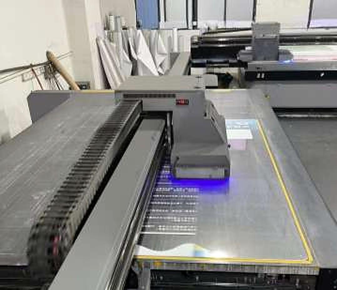 Flatbed UV printer photographed in the company brochure